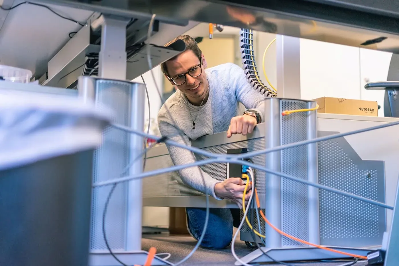 IT-Kollege_verkabelt_unter_Schreibtisch